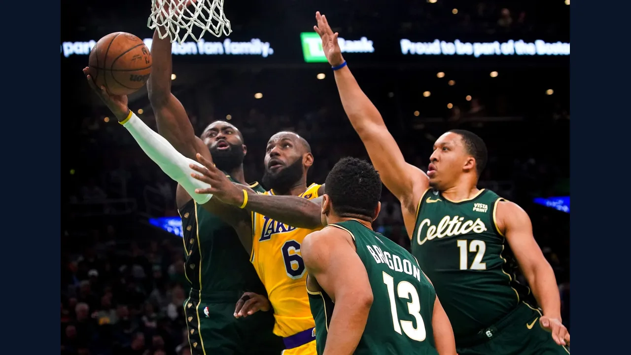 Basketball players contesting a shot under arena lights