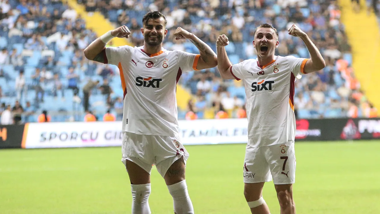 Two soccer players celebrating a goal in a stadium