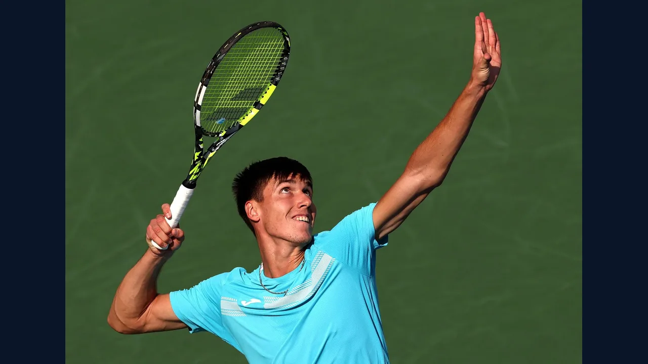 Tennis player serving on court