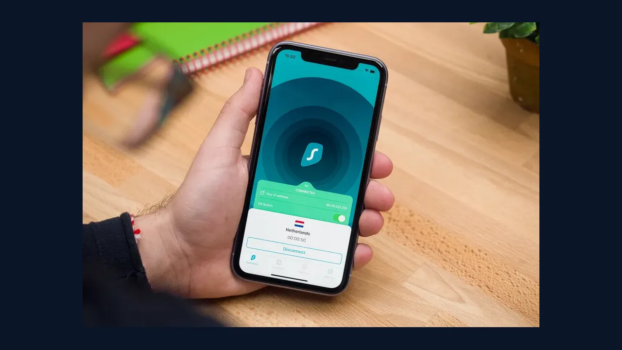 Hand holding a phone showing a VPN app screen