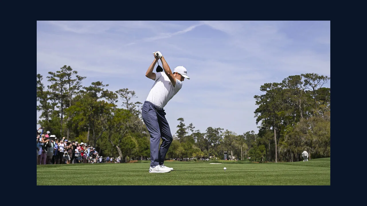 Golfer swinging on a course