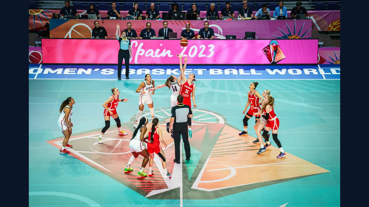 Women players on an indoor basketball court during a game